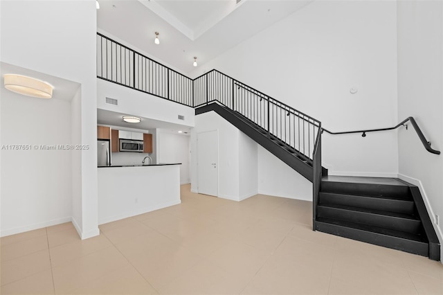 300 S Biscayne Blvd Unit L-802, Miami, FL 33131 - unfurnished living room with a high ceiling, stairway, and baseboards