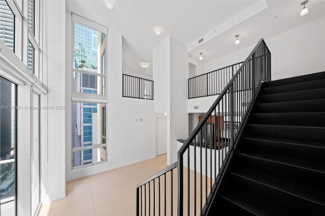 300 S Biscayne Blvd Unit L-802, Miami, FL 33131 - staircase featuring a towering ceiling and tile patterned flooring
