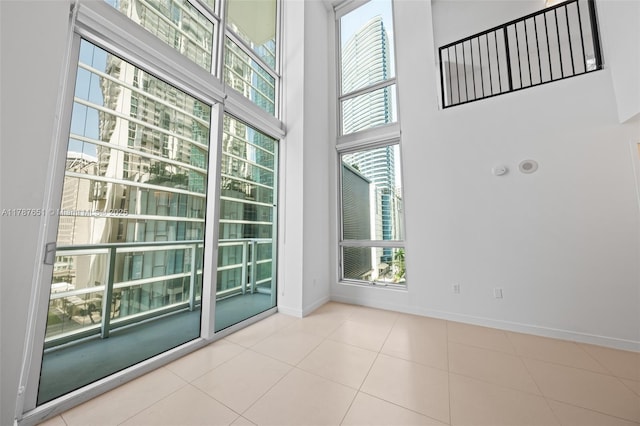300 S Biscayne Blvd Unit L-802, Miami, FL 33131 - spare room featuring a high ceiling, baseboards, and tile patterned floors