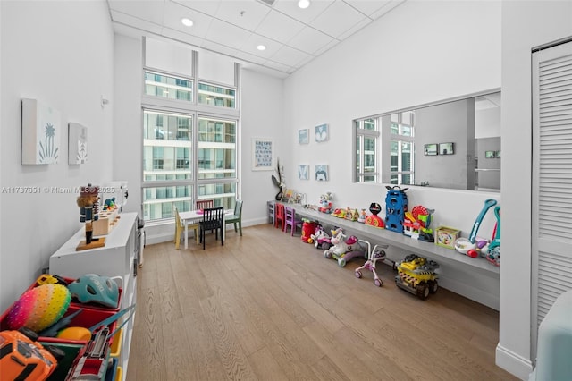 300 S Biscayne Blvd Unit L-802, Miami, FL 33131 - game room featuring wood finished floors, recessed lighting, a towering ceiling, and baseboards