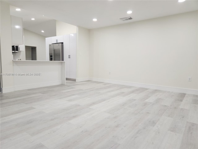 unfurnished living room featuring recessed lighting, visible vents, and light wood finished floors