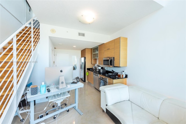 60 SW 13th St Unit 2609, Miami, FL 33130 - kitchen featuring stainless steel appliances, brown cabinetry, an office area, glass insert cabinets, and light tile patterned flooring