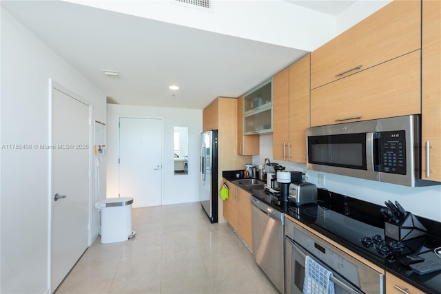60 SW 13th St Unit 2609, Miami, FL 33130 - kitchen with stainless steel appliances, dark countertops, light tile patterned flooring, and modern cabinets