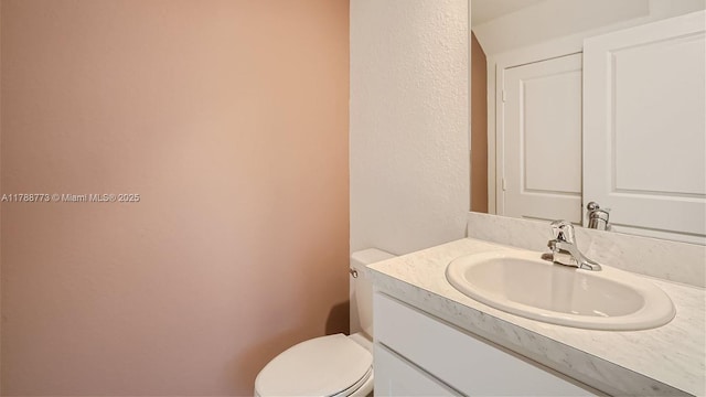 1326 NE 3rd Ave, Florida City, FL 33034 - half bath with a textured wall, vanity, and toilet
