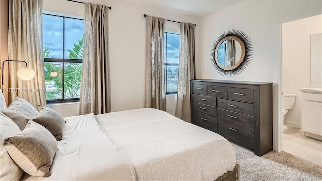1326 NE 3rd Ave, Florida City, FL 33034 - bedroom with light colored carpet, multiple windows, and ensuite bathroom