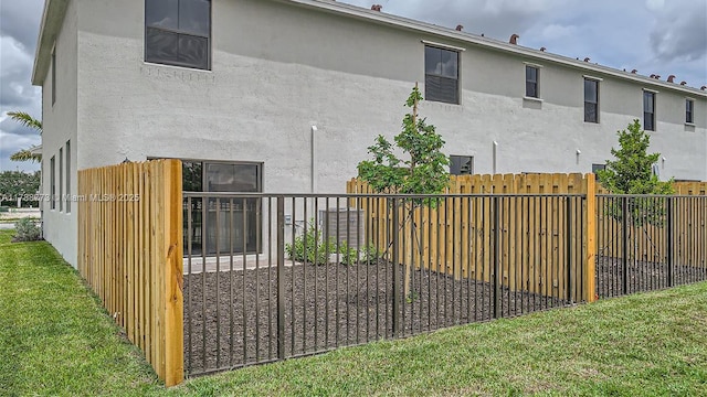 1326 NE 3rd Ave, Florida City, FL 33034 - back of house with a yard, stucco siding, and fence