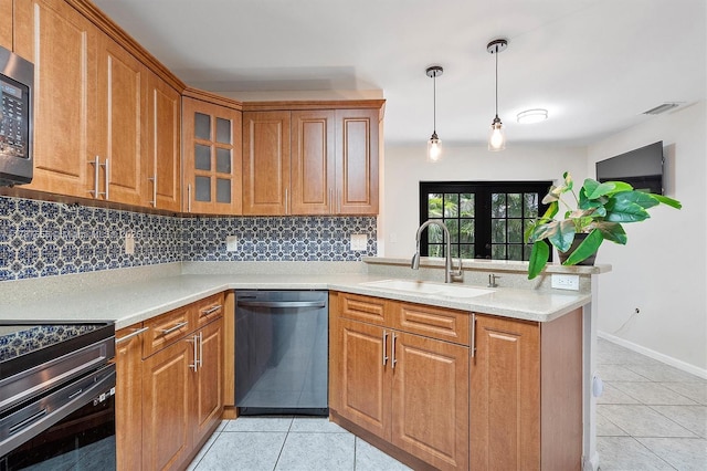 kitchen with brown cabinetry, dishwashing machine, a sink, and light tile patterned floors