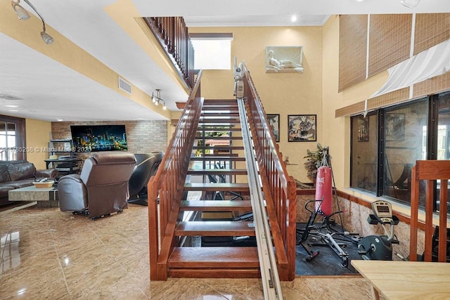 stairs featuring visible vents and a fireplace