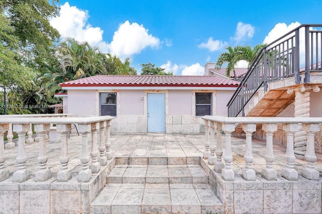 exterior space with outdoor dry bar and stairway