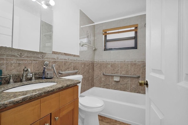 full bathroom with tile walls, toilet, vanity, and shower / washtub combination