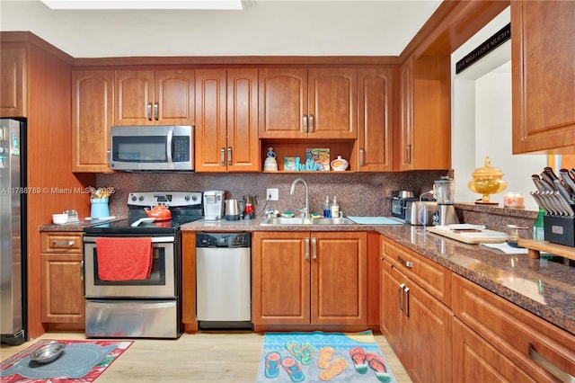 3904 Estepona Ave Unit 8D2, Doral, FL 33178 - kitchen with stainless steel appliances, a sink, and brown cabinetry