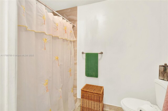 3904 Estepona Ave Unit 8D2, Doral, FL 33178 - bathroom with toilet, curtained shower, and tile patterned floors