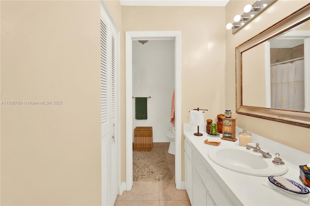 3904 Estepona Ave Unit 8D2, Doral, FL 33178 - bathroom featuring a closet, vanity, toilet, baseboards, and tile patterned flooring