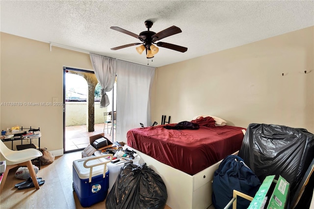 3904 Estepona Ave Unit 8D2, Doral, FL 33178 - bedroom with access to exterior, wood finished floors, a textured ceiling, and ceiling fan
