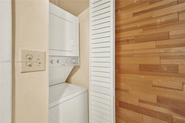 3904 Estepona Ave Unit 8D2, Doral, FL 33178 - laundry area with stacked washer / dryer and wood walls