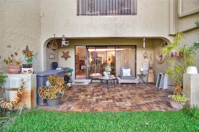 3904 Estepona Ave Unit 8D2, Doral, FL 33178 - view of exterior entry featuring stucco siding and a patio