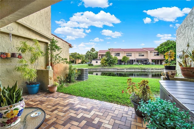 3904 Estepona Ave Unit 8D2, Doral, FL 33178 - view of green lawn featuring a water view, central AC unit, and a patio