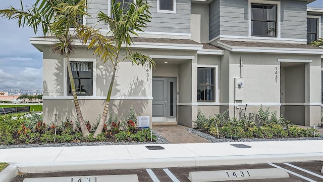 1424 NE 3rd Ave, Florida City, FL 33034 - doorway to property featuring uncovered parking and stucco siding