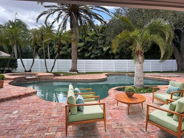 15242 SW 147th Ter, Miami, FL 33196 - view of swimming pool with a fenced backyard, a patio area, and a pool with connected hot tub