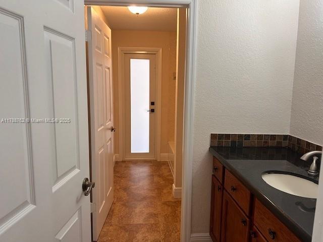 15242 SW 147th Ter, Miami, FL 33196 - bathroom with vanity, a tub, and backsplash
