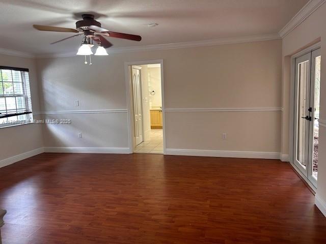 15242 SW 147th Ter, Miami, FL 33196 - empty room with ornamental molding, wood finished floors, baseboards, and a ceiling fan