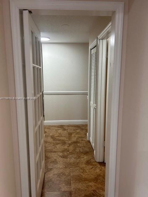 15242 SW 147th Ter, Miami, FL 33196 - hall featuring baseboards and stone finish floors