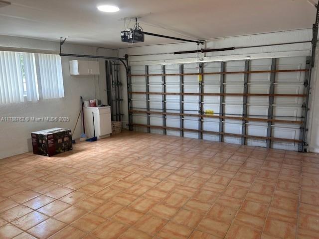 15242 SW 147th Ter, Miami, FL 33196 - garage featuring a garage door opener
