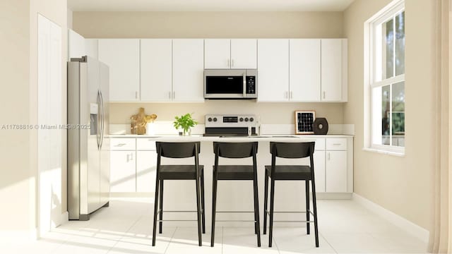 2650 SE 24th Ct, Homestead, FL 33034 - kitchen featuring stainless steel refrigerator with ice dispenser, range, light countertops, and a breakfast bar area