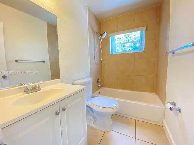 full bathroom with tile patterned floors, toilet, shower / washtub combination, a textured wall, and vanity