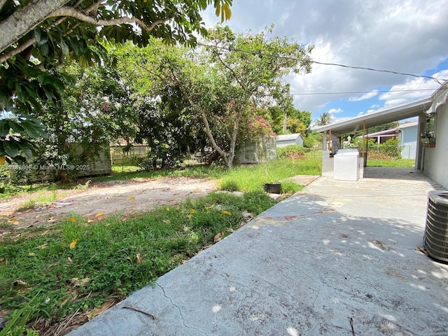 view of yard with cooling unit, a patio area, and fence