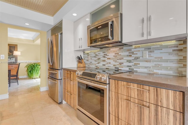 2000 Towerside Ter Unit 702, Miami, FL 33138 - kitchen with modern cabinets, tasteful backsplash, dishwasher, a sink, and white cabinetry