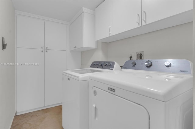 2000 Towerside Ter Unit 702, Miami, FL 33138 - clothes washing area with cabinet space, light tile patterned flooring, baseboards, and washer and clothes dryer