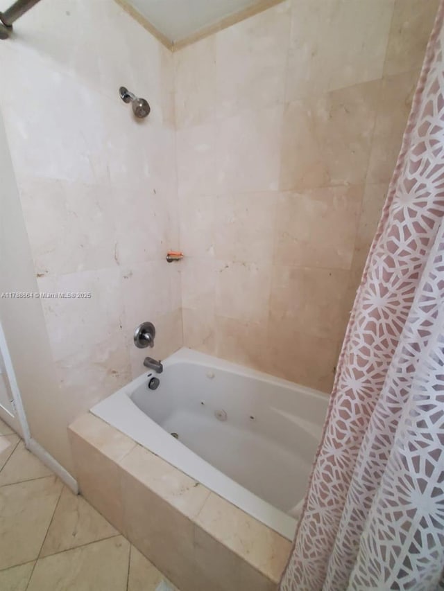 bathroom with tile patterned flooring and tiled shower / bath