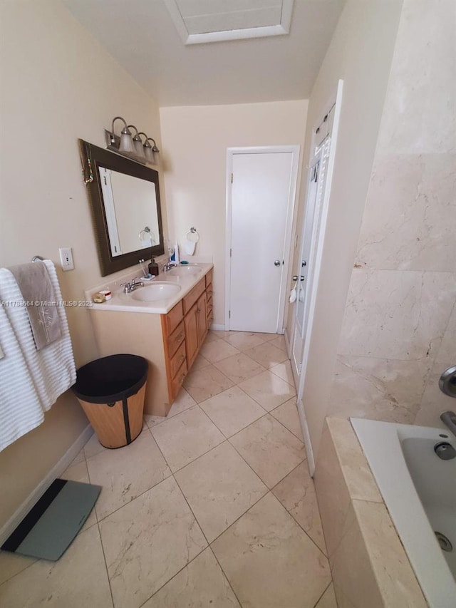 full bathroom with vanity, a bathtub, and marble finish floor