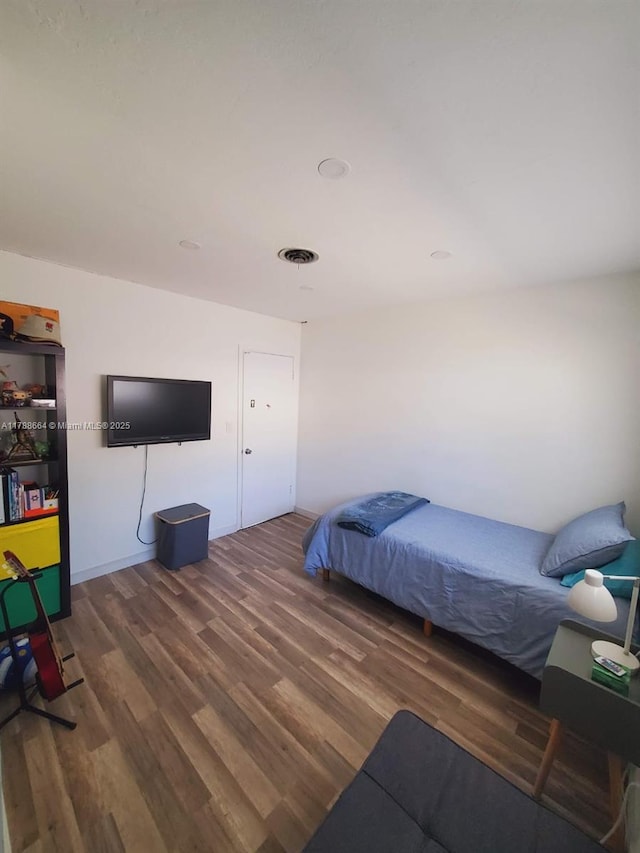 bedroom with wood finished floors