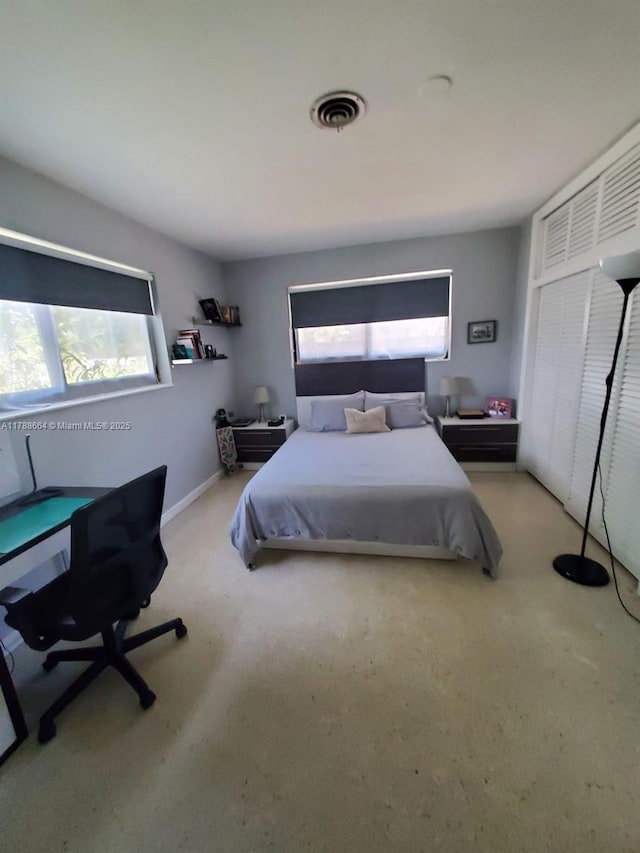 carpeted bedroom featuring multiple windows and visible vents