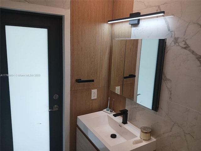 bathroom with tile walls and vanity