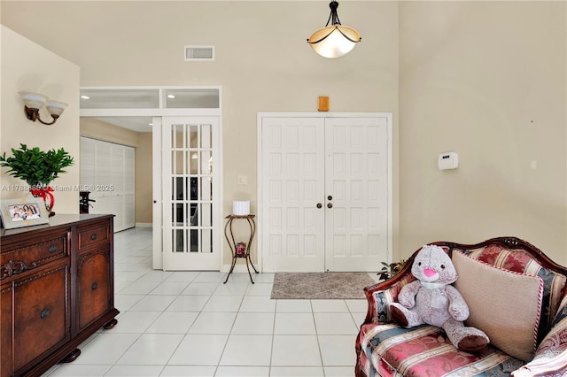 3939 Adra Ave Unit A-47, Doral, FL 33178 - entrance foyer with a towering ceiling, visible vents, and light tile patterned floors