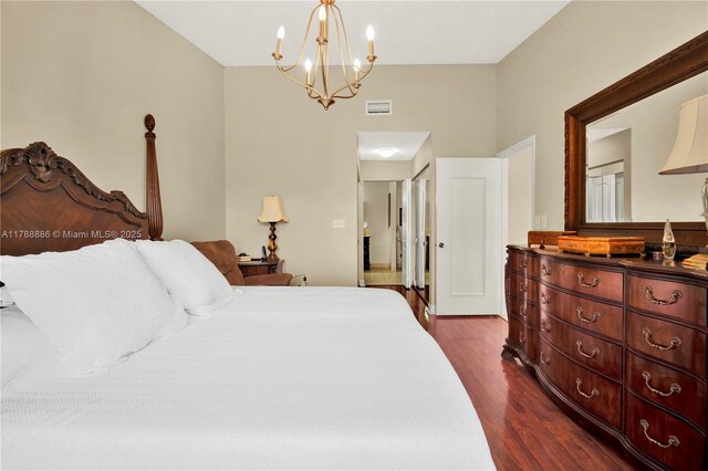3939 Adra Ave Unit A-47, Doral, FL 33178 - bedroom featuring a notable chandelier, dark wood-style flooring, and visible vents