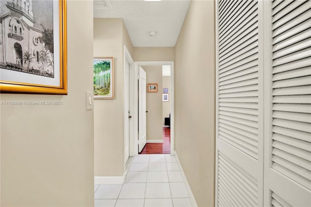 3939 Adra Ave Unit A-47, Doral, FL 33178 - hallway with light tile patterned flooring and baseboards
