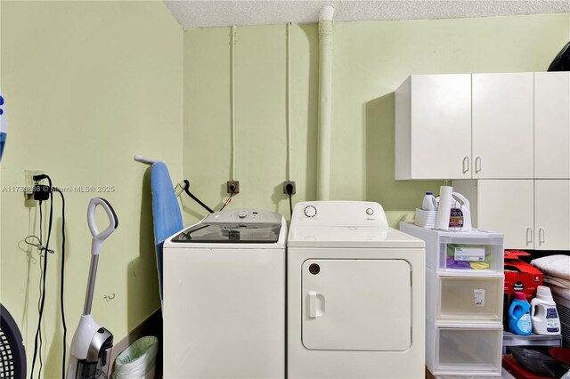 3939 Adra Ave Unit A-47, Doral, FL 33178 - clothes washing area with cabinet space, a textured ceiling, and washing machine and clothes dryer