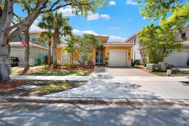 20656 SW 89th Ave, Cutler Bay, FL 33189 - mediterranean / spanish home with driveway, stucco siding, an attached garage, and a tile roof