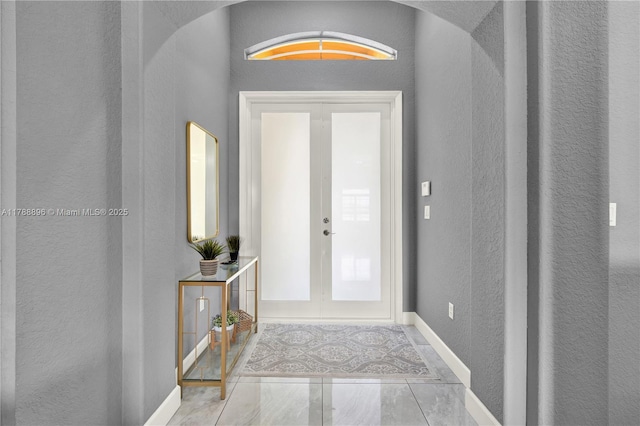 20656 SW 89th Ave, Cutler Bay, FL 33189 - foyer entrance with arched walkways, a textured wall, french doors, and baseboards