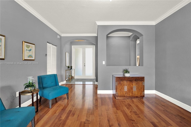 20656 SW 89th Ave, Cutler Bay, FL 33189 - sitting room with crown molding, arched walkways, wood finished floors, and baseboards