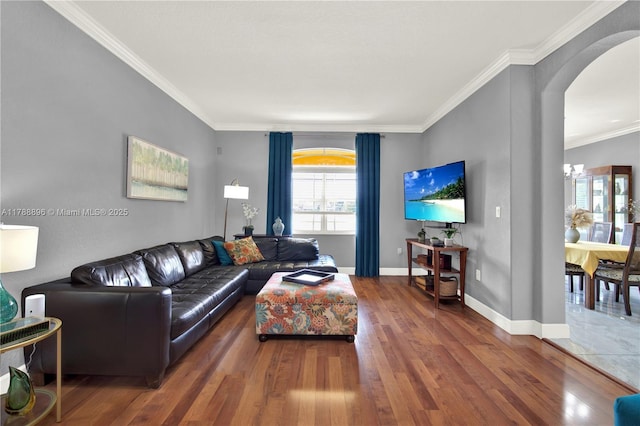 20656 SW 89th Ave, Cutler Bay, FL 33189 - living room featuring crown molding, baseboards, arched walkways, wood finished floors, and a notable chandelier
