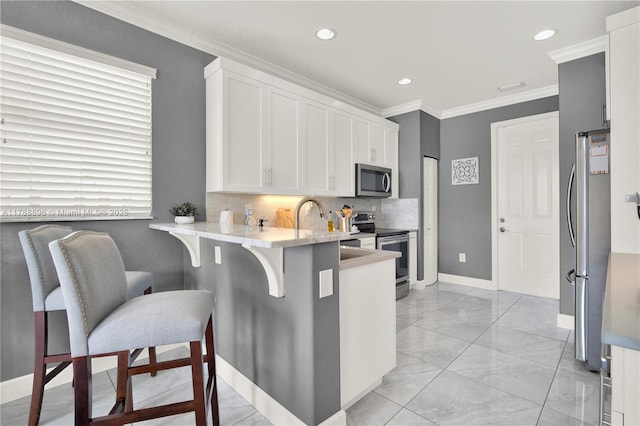 20656 SW 89th Ave, Cutler Bay, FL 33189 - kitchen with stainless steel appliances, crown molding, marble finish floor, a peninsula, and white cabinets