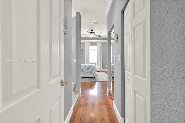 20656 SW 89th Ave, Cutler Bay, FL 33189 - corridor featuring visible vents, wood finished floors, and a textured wall