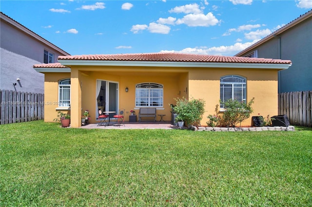 20656 SW 89th Ave, Cutler Bay, FL 33189 - back of house with a fenced backyard, stucco siding, a tile roof, a patio area, and a lawn