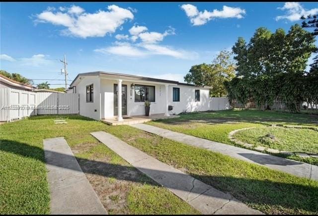 11245 SW 47th Ter, Miami, FL 33165 - view of front of house with stucco siding, a gate, fence, and a front yard