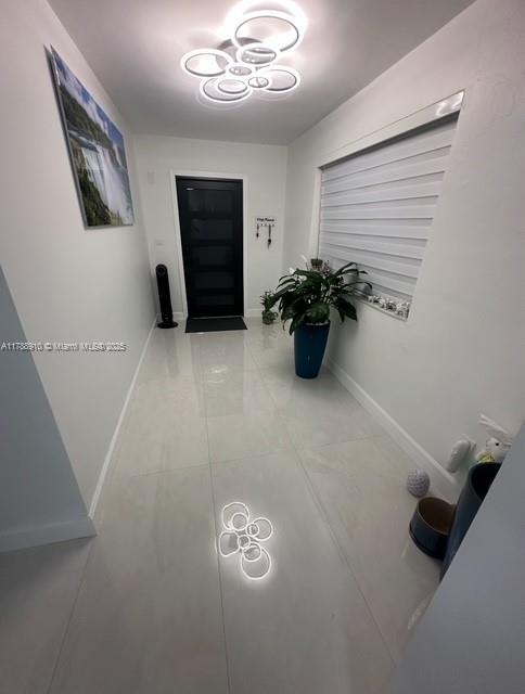 11245 SW 47th Ter, Miami, FL 33165 - hall featuring tile patterned floors and baseboards